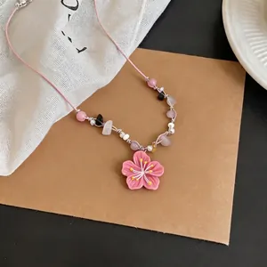 Cute pink flower pendant necklace with colorful beads in a vibrant dopamine style.