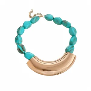 Bohemian vintage necklace with turquoise acrylic beads and gold curved metal pendant.