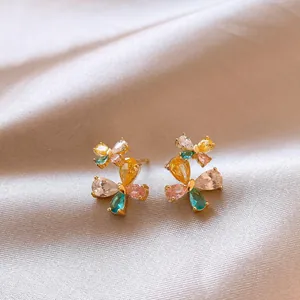 Macro view of colorful butterfly stud earrings with sparkling multi-color cubic zirconia.