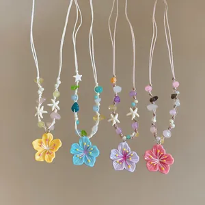Detailed view of colorful dopamine style flower pendant necklaces featuring cute beaded cords