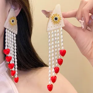 Elegant vintage resin tassel earrings featuring white pearls and red heart charms