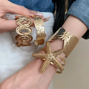 Luxury gold sea star and irregular wrinkled textured metal open cuff bracelets for women