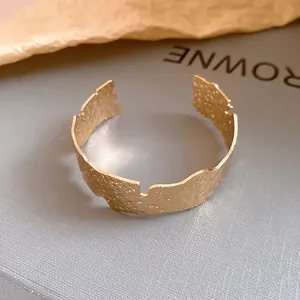 Elegant gold hammered irregular open cuff bracelet with a luxury textured finish