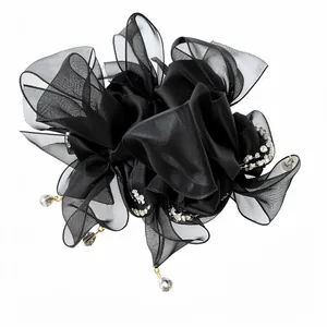 Chouchou élégant en mousseline noire avec nœud, strass et pampilles en cristal.