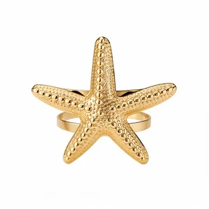 Elegant gold starfish cuff bracelet with textured beaded design on white background
