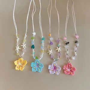 Detail view of colorful dopamine style flower beaded necklaces in four vibrant pastel shades