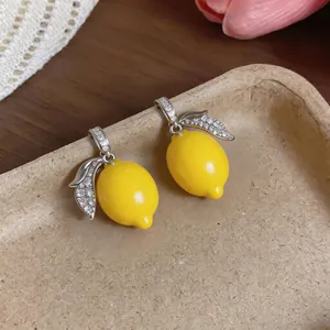 Close-up detail of micro-set zircon lemon charms featuring a vibrant yellow finish