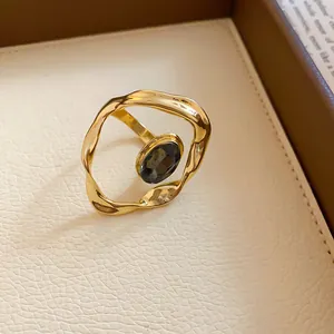Detailed macro shot of a vintage gold pleated ring with central oval black gemstone