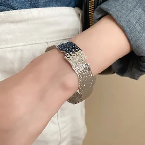Minimalist silver irregular wrinkled cuff bracelet with a liquid metal texture