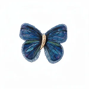 Elegant knitted butterfly hair clip with vintage blue embroidery and gold-toned body