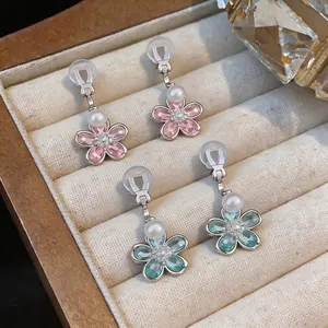 Sparkling crystal pearl flower clip-on earrings in pink and green for non-pierced ears.