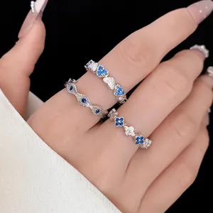 Detailed view of elegant silver open rings featuring vibrant blue zircon heart and flowers