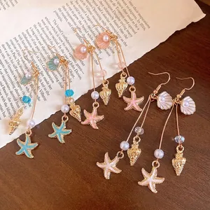 Elegant sea shell and starfish pearl drop earrings perfect for a beach vacation look.