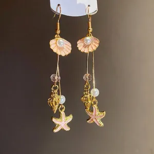 Elegant gold-plated drop earrings with sea shells starfish and pearls for vacation