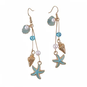 Elegant gold beach style earrings with blue enamel starfish, seashells and pearls