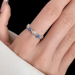 Close-up detail of a silver-tone open ring with blue and white zircon flower pattern
