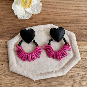Vintage heart-shaped wooden earrings with pink beads and ethnic glass accents