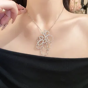 Primo piano di un'elegante collana con ciondolo a fiore traforato placcato oro 18 carati