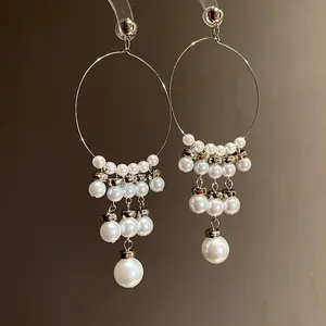 Detailed view of elegant French vintage hoop earrings with tiered pearl tassels