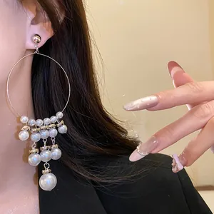 Detailed view of elegant French vintage silver hoop earrings with multi-layered pearl tassels