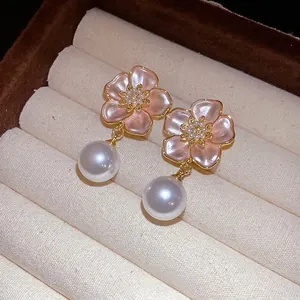 Elegant gold-tone zircon oil-drop flower stud earrings with large white pearl dangles