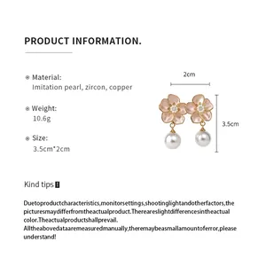 Detail view of floral pearl earrings with size dimensions and material info