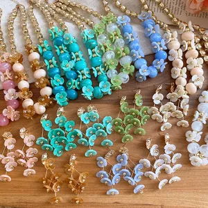 Colorful acrylic beaded flower necklaces and earrings in bohemian vacation style.
