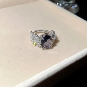 Vista macro di un anello vintage con gemma viola e motivi a piuma in zircone brillante