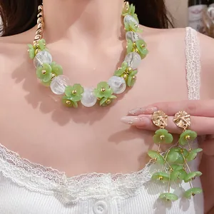 Elegant green flower acrylic bead necklace and matching earrings set on model