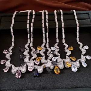 Close-up detail of five elegant teardrop zircon necklaces in various vibrant colors