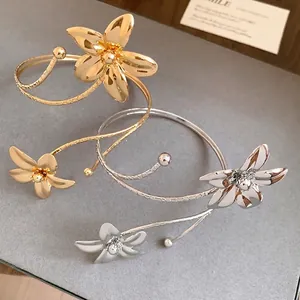 Elegant spiral metal flower open bracelet and arm cuff in gold and silver finishes.