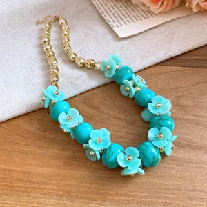 Detailed close-up of a light blue acrylic flower beaded necklace in resort style.