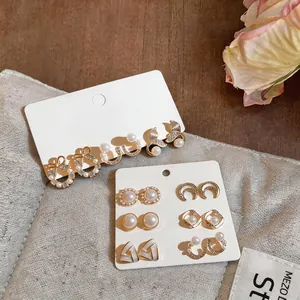 Close-up detail of mixed pearl and rhinestone stud earring sets on elegant display cards