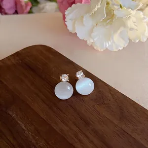 Minimalist round cat's eye stone stud earrings with zircon accents in gold finish