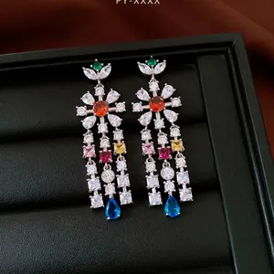 Vintage-style zircon flower earrings with colorful water drop tassels on a black box