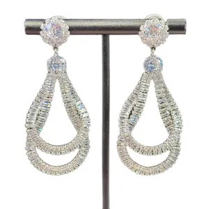 Elegant palace style teardrop dangle earrings with heavy cubic zirconia on white background