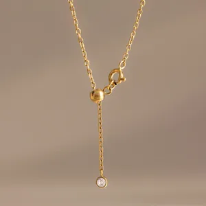 Detail view of 18k gold-plated stainless steel adjustable bracelet with a white zircon charm