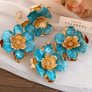 Close-up of vintage palace-style metal enamel flower earrings with elegant gold flower heart