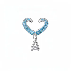 Elegant heart-shaped silver-toned ear cuff with blue zircons and clear cubic zirconia stone drop