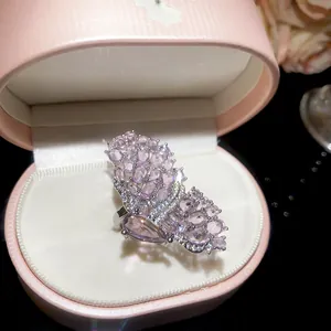 Close-up of a silver butterfly open ring with pink stones in a pink gift box