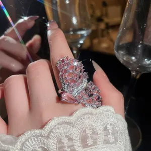 Close-up detail of a luxury hollow butterfly ring featuring sparkling pink micro-pave crystals