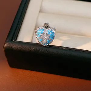 Detailed close-up of a heart-shaped blue zircon silver ear clip for non-pierced ears