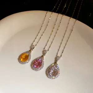 Close-up detail of elegant zircon water drop pendant necklaces in three radiant colors.