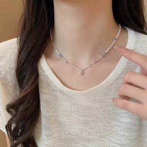 Elegant square crystal and pearl beaded necklace worn as a minimalist clavicle chain