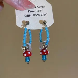 Retro cute mushroom drop earrings with red and blue glass beads and flower detail.