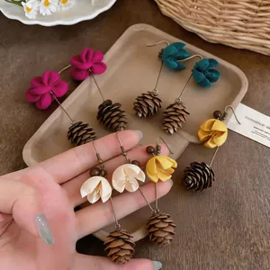 Detailed view of forest-style flower and pinecone drop earrings in various colors.