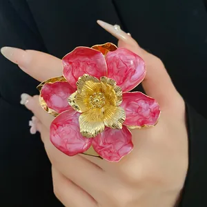 Close-up detail of vintage pink enamel flower earring with gold-tone metallic textures