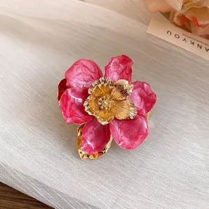 Close-up detail of vintage pink enamel flower earring with golden metallic center petals
