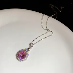Detail macro shot of a brilliant teardrop pink zircon pendant on a silver chain necklace