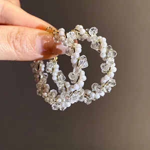 Handcrafted exaggerated crystal and pearl beaded hoop earrings with gold wire wrap design